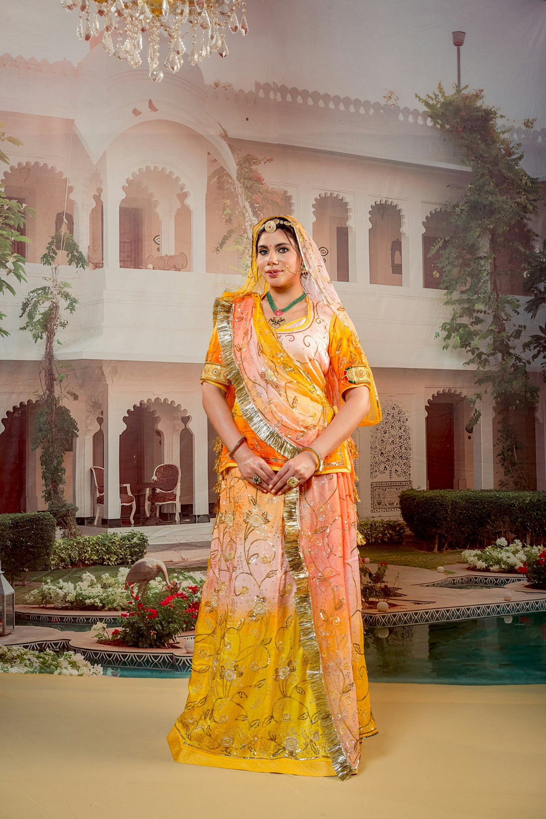 Young woman in traditional Indian attire before a palace — rewearing an Anarkali five different ways