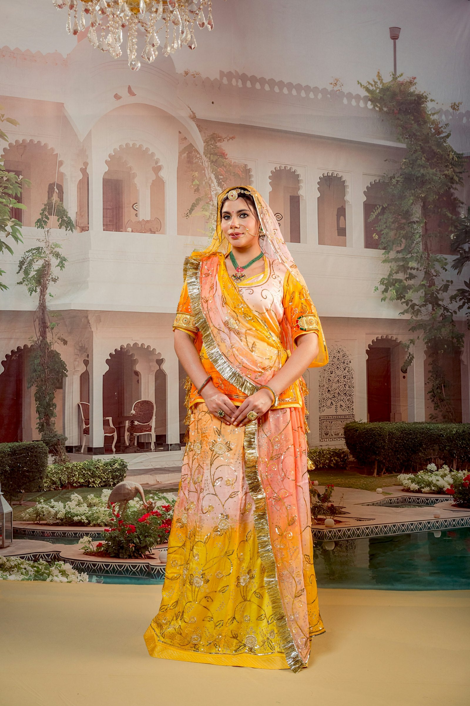 Young woman in traditional Indian attire before a palace — rewearing an Anarkali five different ways